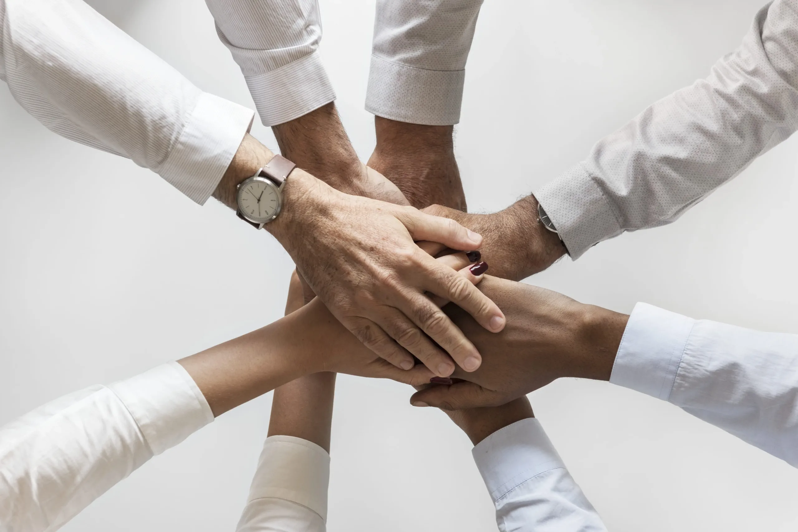 business-hands-joined-together-teamwork (1)